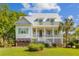 Charming two-story home features a welcoming front porch, well-manicured lawn, and mature landscaping at 112 Berkshire Dr, Wando, SC 29492