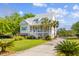 Beautiful two-story home with a metal roof, inviting porch, and manicured landscaping at 112 Berkshire Dr, Wando, SC 29492