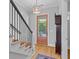 Elegant foyer features hardwood floors, staircase, and views to the front yard at 112 Berkshire Dr, Wando, SC 29492