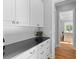 Pantry area with white cabinets, black countertop, and modern finishes at 112 Berkshire Dr, Wando, SC 29492
