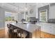 Bright, spacious kitchen features a large center island with bar seating and gray backsplash at 112 Berkshire Dr, Wando, SC 29492