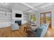 Open living room boasts built-in shelving, coffered ceilings, and hardwood floors at 112 Berkshire Dr, Wando, SC 29492
