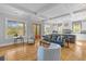Bright and open living room with hardwood floors, large windows, and seamless flow to kitchen at 112 Berkshire Dr, Wando, SC 29492