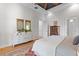 A well-lit main bedroom offers an eye-catching mirror, hardwood floors, and ample space at 112 Berkshire Dr, Wando, SC 29492