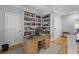 Bright office space featuring custom built-in bookshelves and a large desk, perfect for working from home at 112 Berkshire Dr, Wando, SC 29492