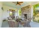 Comfortable porch with stone fireplace and cozy seating area at 112 Berkshire Dr, Wando, SC 29492