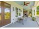 Inviting porch with a rustic table and water views from the windows at 112 Berkshire Dr, Wando, SC 29492