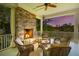 Relaxing outdoor porch with a stone fireplace and comfortable seating, perfect for enjoying evenings at 112 Berkshire Dr, Wando, SC 29492