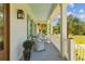 Inviting porch with white wicker furniture and blue ceiling is great for relaxing at 112 Berkshire Dr, Wando, SC 29492