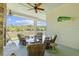 Relaxing porch area with chairs, ceiling fan, and fireplace near the water at 112 Berkshire Dr, Wando, SC 29492