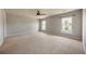 Spacious bedroom with neutral carpet, fan, and large windows providing natural light at 1130 Moss Grove Dr, Moncks Corner, SC 29461