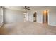 Bright bedroom featuring neutral carpet, ceiling fan, and three doors leading to other rooms at 1130 Moss Grove Dr, Moncks Corner, SC 29461