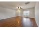 Inviting living room featuring hardwood floors, ceiling fan, neutral paint, and natural light from the large window creating a cozy ambiance at 1130 Moss Grove Dr, Moncks Corner, SC 29461