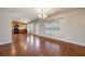 Inviting living space showcasing hardwood floors, bright windows, and seamlessly connecting to the adjacent kitchen area for easy entertaining at 1130 Moss Grove Dr, Moncks Corner, SC 29461