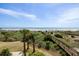 The beautiful ocean and beach views from above are surrounded by trees and offer a lovely walkway down to the beach at 1140 Ocean Blvd # 201, Isle of Palms, SC 29451