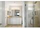 The primary bathroom includes a double vanity, full mirror, and a separate glass enclosed shower at 1140 Ocean Blvd # 201, Isle of Palms, SC 29451