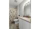 Well-maintained bathroom with neutral tones and a decorative seashell-themed shower curtain at 1140 Ocean Blvd # 201, Isle of Palms, SC 29451