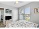 Bright bedroom featuring a ceiling fan, light walls, and a window with a view at 1140 Ocean Blvd # 201, Isle of Palms, SC 29451