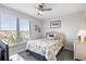 Cozy bedroom with a wicker bed frame, ceiling fan, and bright window view at 1140 Ocean Blvd # 201, Isle of Palms, SC 29451