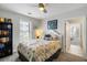 Relaxing bedroom with bright light, a view to another room, and coastal decorations at 1140 Ocean Blvd # 201, Isle of Palms, SC 29451