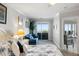 This is a bright bedroom with access to the patio and ocean views with a comfortable seating area at 1140 Ocean Blvd # 201, Isle of Palms, SC 29451