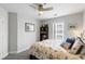 Comfortable bedroom featuring a ceiling fan, bright window, and a bookshelf for storage at 1140 Ocean Blvd # 201, Isle of Palms, SC 29451