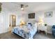 The bright bedroom has a queen bed, ceiling fan, and ensuite bathroom with a glass-enclosed shower at 1140 Ocean Blvd # 201, Isle of Palms, SC 29451