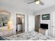 Well-lit bedroom boasts a view to the bathroom, a ceiling fan, and tasteful decor at 1140 Ocean Blvd # 201, Isle of Palms, SC 29451