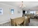 Well-lit dining area with wood table and chairs, complemented by light walls and views into the adjacent living space at 1140 Ocean Blvd # 201, Isle of Palms, SC 29451