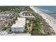 Aerial view of a multi-story building with a pool, a parking lot, beach access, and lush landscaping at 1140 Ocean Blvd # 201, Isle of Palms, SC 29451