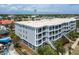 An aerial shot of a multi-story building with beach access, private balconies and lush landscaping at 1140 Ocean Blvd # 201, Isle of Palms, SC 29451