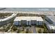 Aerial view of a multi-story building with beach access, a parking lot, and lush landscaping at 1140 Ocean Blvd # 201, Isle of Palms, SC 29451
