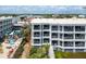 Aerial view of a multi-story building, offering private balconies, beach access, and lush landscaping at 1140 Ocean Blvd # 201, Isle of Palms, SC 29451
