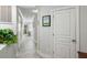 Hallway entrance boasts neutral walls and an art accent, leading to a sunlit space with a kitchen island at 1140 Ocean Blvd # 201, Isle of Palms, SC 29451