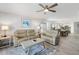 Bright living room with comfortable seating, ceiling fan, and hardwood-style flooring in an open concept floor plan at 1140 Ocean Blvd # 201, Isle of Palms, SC 29451