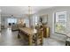Open living space showcases dining area, ocean view through sliding doors, and stylish neutral decor at 1140 Ocean Blvd # 201, Isle of Palms, SC 29451