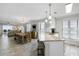 Open living area featuring island with bar stools and open to a comfortable dining space with ocean view at 1140 Ocean Blvd # 201, Isle of Palms, SC 29451