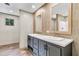 Bathroom with dual sinks, stylish vanity, framed mirrors, and tiled walls, blending functionality with a modern design at 119 Silver King Ave, Cross, SC 29436