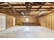 An unfinished garage featuring wood beams, concrete flooring, a workbench, and a door to outside at 119 Silver King Ave, Cross, SC 29436