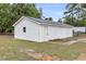 View of a two-car garage with white siding and a metal roof with a small yard surrounding it at 119 Silver King Ave, Cross, SC 29436