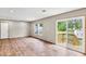 Open-concept living room with hardwood floors and a sliding door to backyard at 119 Silver King Ave, Cross, SC 29436