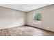 An unfurnished room featuring wood-look floors, neutral walls, and a large window, offering a blank canvas at 119 Silver King Ave, Cross, SC 29436
