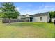 Large backyard with lush green grass, mature trees, and a screened porch at 121 Keaton Brook Dr, Summerville, SC 29485