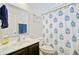 Well-lit bathroom with a large mirror and vanity with a shower and blue patterned shower curtain at 121 Keaton Brook Dr, Summerville, SC 29485
