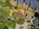 Aerial view of a home with mature trees, a circular driveway, and a backyard with a deck and a large red star on the roof at 1224 Decoy Ct, Mount Pleasant, SC 29464
