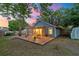 Cozy screened-in porch with a wooden deck and backyard view at dusk at 1224 Decoy Ct, Mount Pleasant, SC 29464