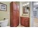 Bathroom with granite countertop vanity, wood cabinets and toilet at 1224 Decoy Ct, Mount Pleasant, SC 29464