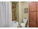 Neutral bathroom features a tiled shower/tub combo, toilet, and built-in storage cabinet at 1224 Decoy Ct, Mount Pleasant, SC 29464