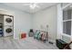 Light filled bedroom features wood-look floors, a ceiling fan, a window, and an in-closet laundry area at 1224 Decoy Ct, Mount Pleasant, SC 29464