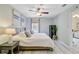 Bright bedroom featuring a ceiling fan, modern light fixtures, a wooden bed frame, and stylish decor, complemented by an indoor plant at 1224 Decoy Ct, Mount Pleasant, SC 29464